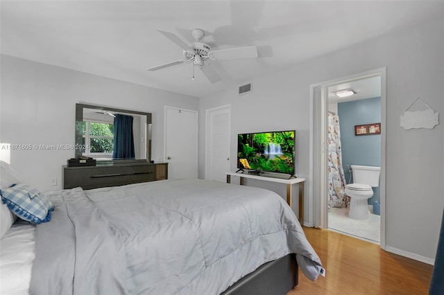 bedroom featuring wood-type flooring, connected bathroom, and ceiling fan