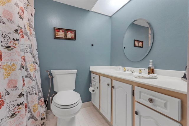 bathroom featuring tile patterned flooring, vanity, and toilet