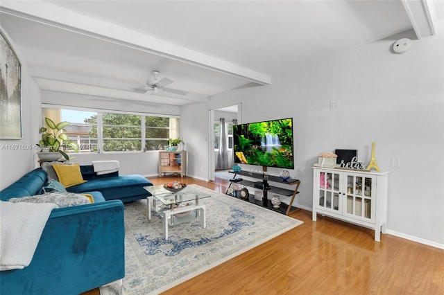 living room with wood-type flooring, beamed ceiling, and ceiling fan