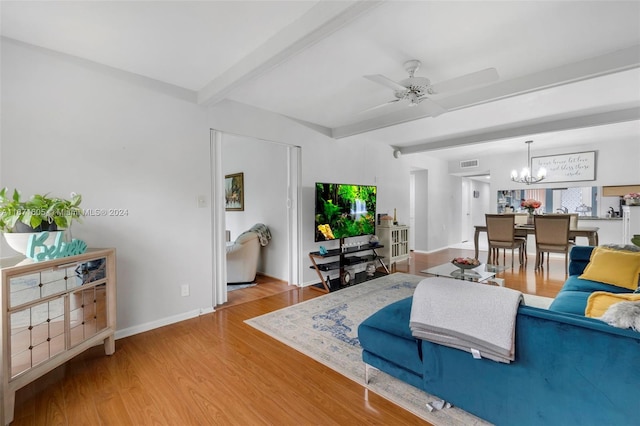 living room featuring wood-type flooring, ceiling fan with notable chandelier, and beam ceiling