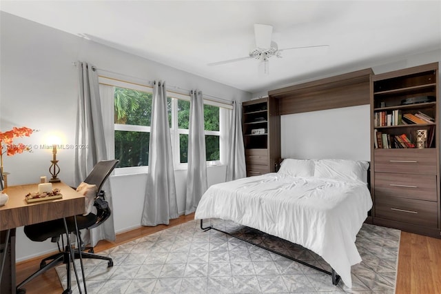 bedroom with ceiling fan and light hardwood / wood-style flooring