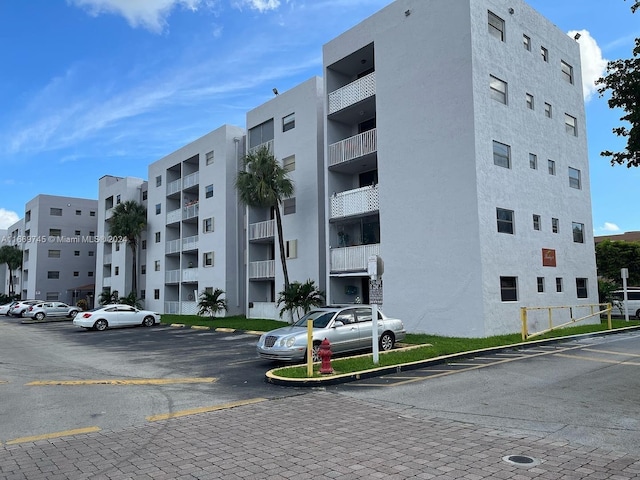 8075 NW 7th St Unit 109, Miami, FL 33126 - view of apartment building / complex featuring uncovered parking