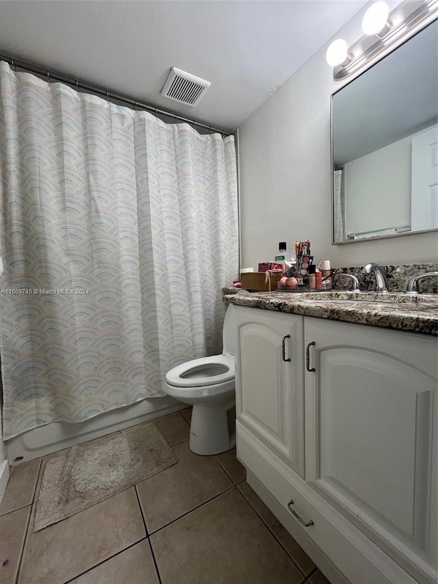 full bathroom with vanity, tile patterned flooring, toilet, and shower / tub combo