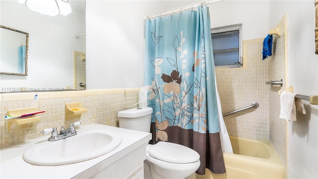 full bathroom with shower / bath combo, vanity, tile walls, and toilet