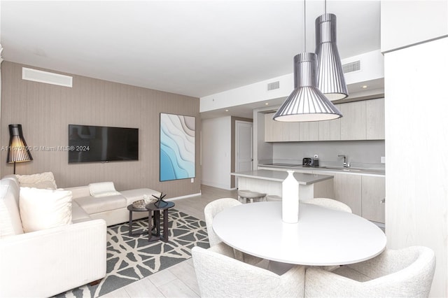 living room featuring light hardwood / wood-style floors and sink