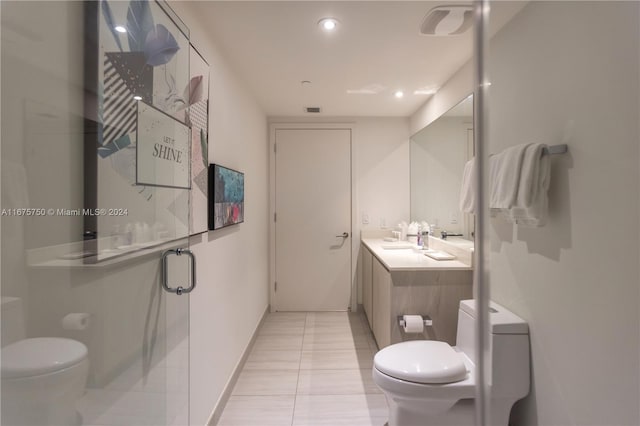 bathroom with vanity, toilet, tile patterned floors, and an enclosed shower