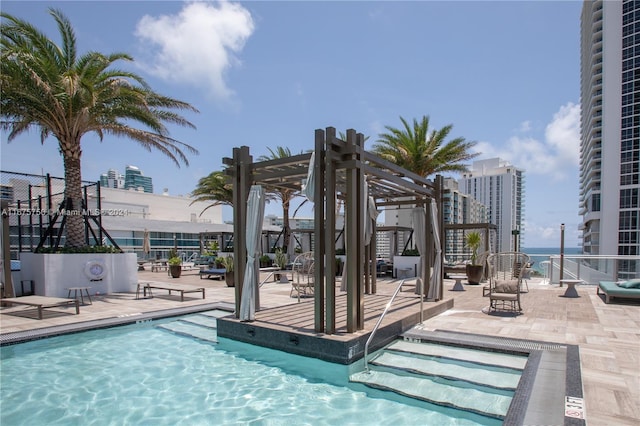 view of pool with a patio area and a pergola