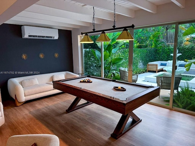 recreation room with beamed ceiling, an AC wall unit, hardwood / wood-style floors, and billiards