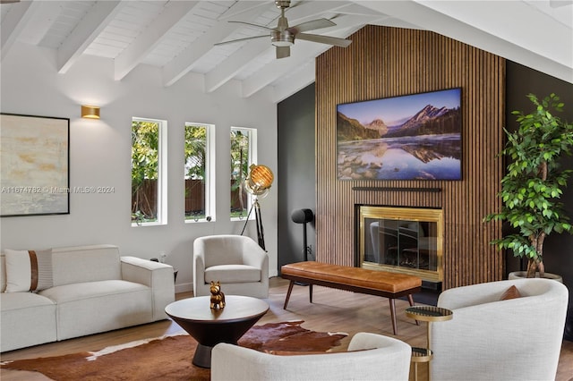 interior space featuring hardwood / wood-style floors, vaulted ceiling with beams, and ceiling fan