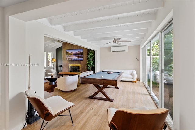 rec room with an AC wall unit, light hardwood / wood-style flooring, beam ceiling, and pool table