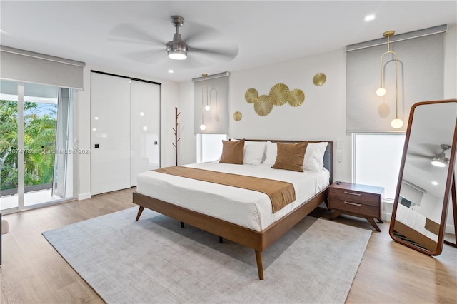 bedroom with access to outside, ceiling fan, and light wood-type flooring