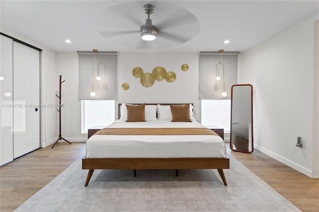 bedroom with ceiling fan and light hardwood / wood-style floors