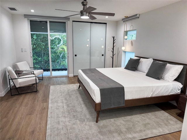 bedroom with access to exterior, wood-type flooring, and ceiling fan