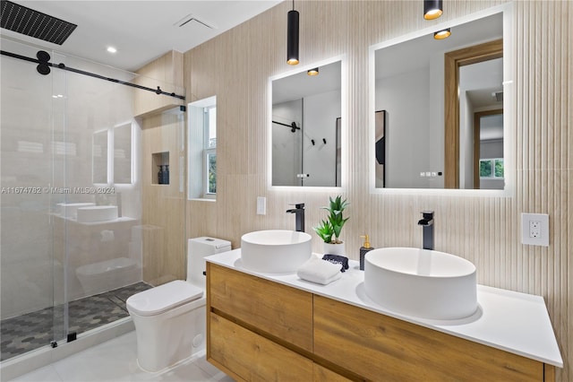 bathroom featuring a healthy amount of sunlight, toilet, and walk in shower