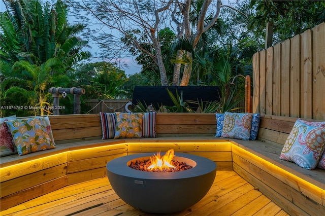 wooden terrace featuring a fire pit