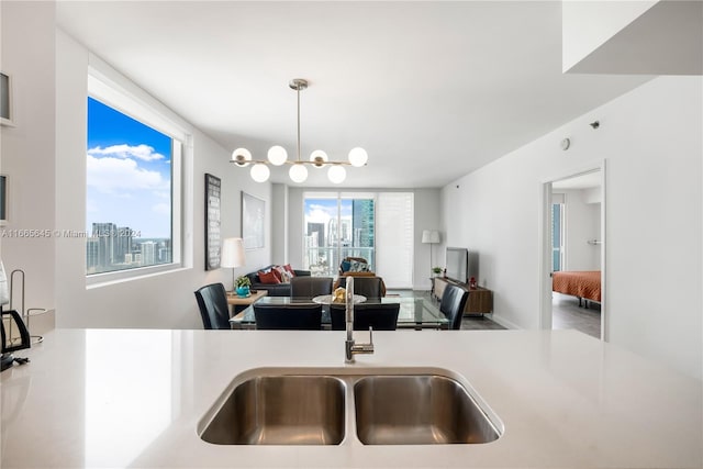 kitchen with hanging light fixtures, sink, and an inviting chandelier