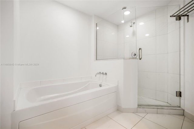 bathroom featuring shower with separate bathtub