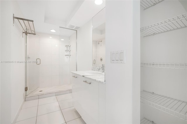 bathroom with vanity, a shower with shower door, and tile patterned flooring