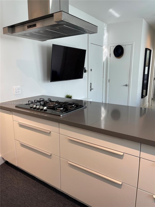 kitchen featuring white cabinetry, black gas cooktop, and wall chimney exhaust hood