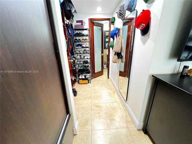 corridor with light tile patterned floors