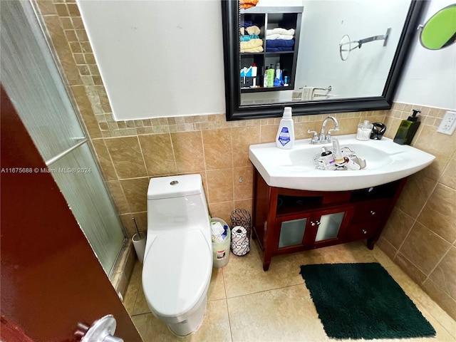 bathroom featuring walk in shower, vanity, tile walls, and toilet