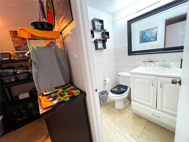 bathroom with tile patterned floors, vanity, tile walls, and toilet