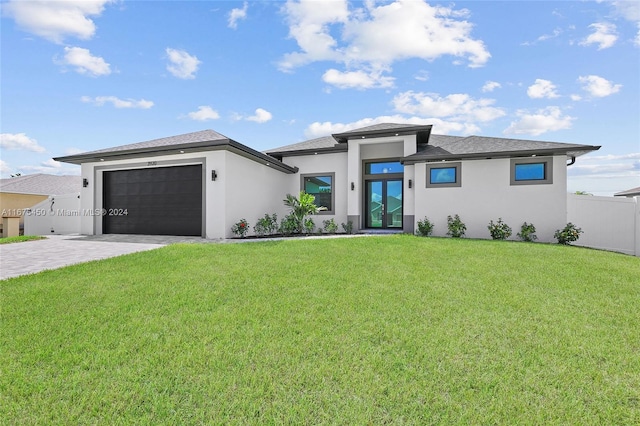 prairie-style house featuring a front yard and a garage