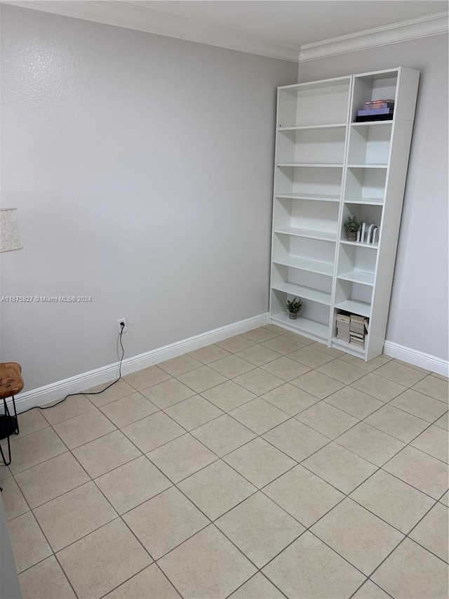 tiled spare room with ornamental molding