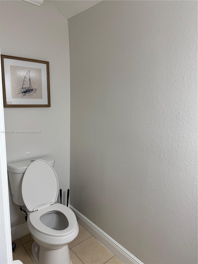 bathroom featuring toilet and tile patterned flooring