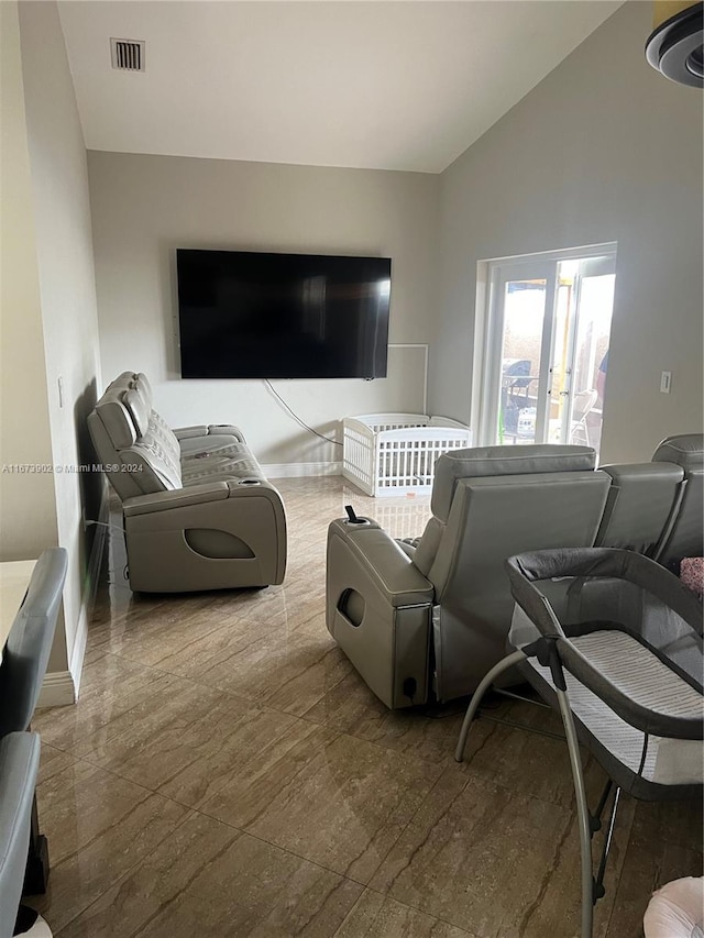 living room featuring vaulted ceiling and hardwood / wood-style flooring