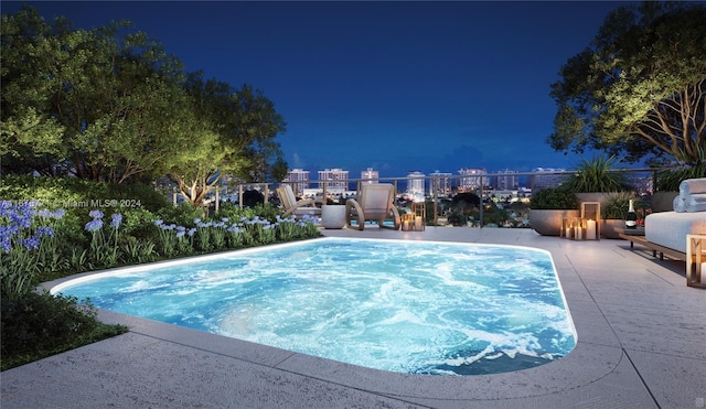 pool at twilight with a patio area