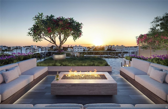 patio terrace at dusk featuring an outdoor living space with a fire pit