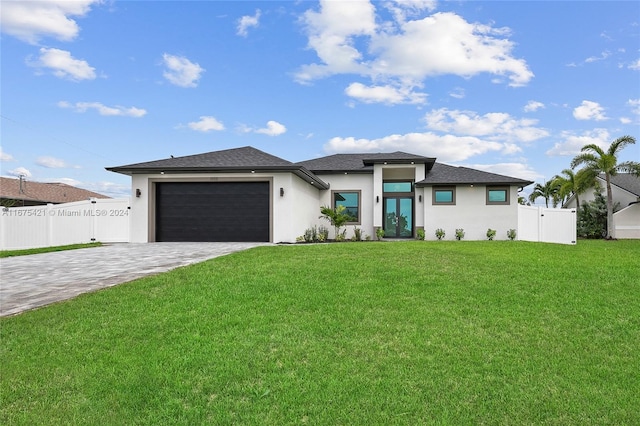 prairie-style home with a front lawn and a garage