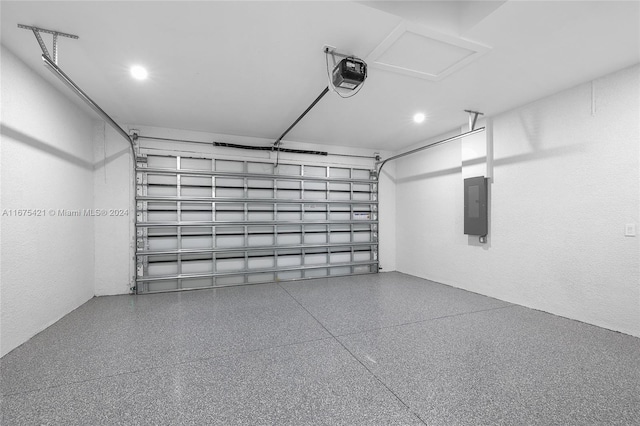 garage with a garage door opener and electric panel