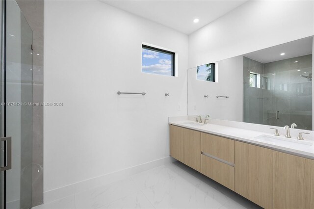 bathroom featuring vanity and an enclosed shower