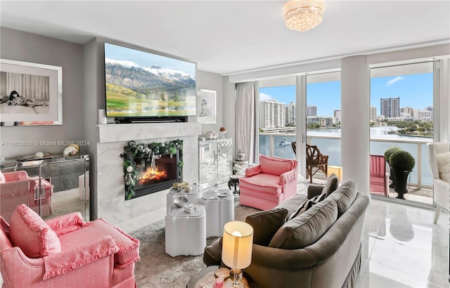 tiled living room featuring a wall of windows, plenty of natural light, and a premium fireplace