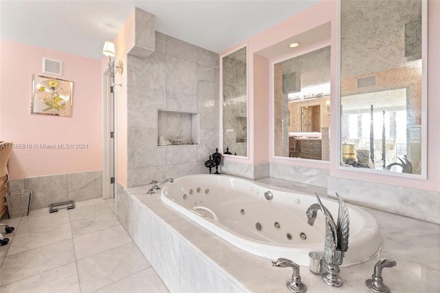 bathroom featuring a relaxing tiled tub, tile walls, and tile patterned flooring