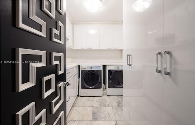 laundry room with crown molding, independent washer and dryer, and cabinets