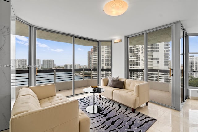 living room featuring floor to ceiling windows and light tile patterned floors