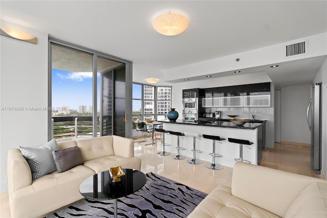 living room with floor to ceiling windows and sink