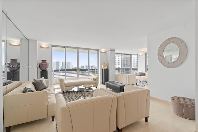 living room featuring light tile patterned flooring and a wall of windows