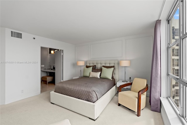 bedroom featuring light colored carpet