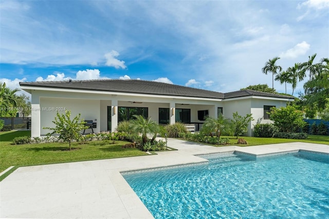 back of house featuring a patio, a lawn, and ceiling fan