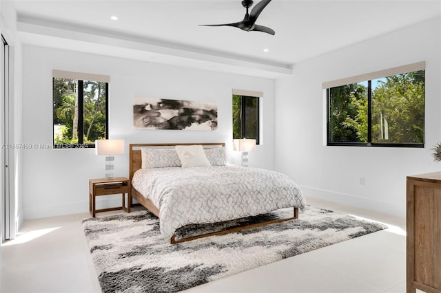 bedroom with multiple windows and ceiling fan