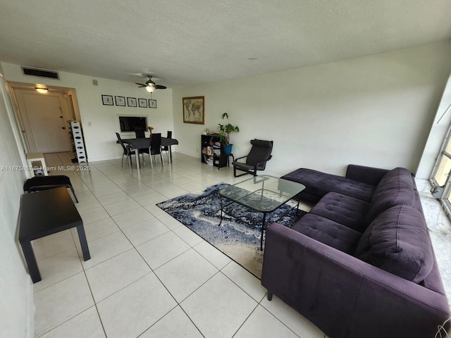 dining area with light tile patterned floors, a textured ceiling, and ceiling fan