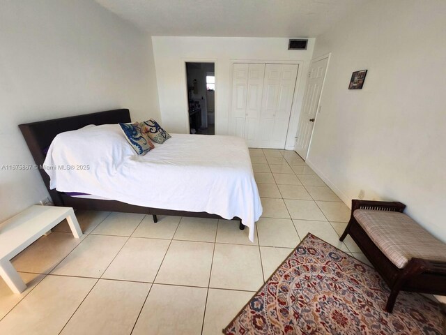 tiled bedroom featuring a textured ceiling