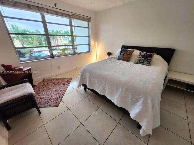 bathroom featuring tile patterned floors, vanity, and a tub