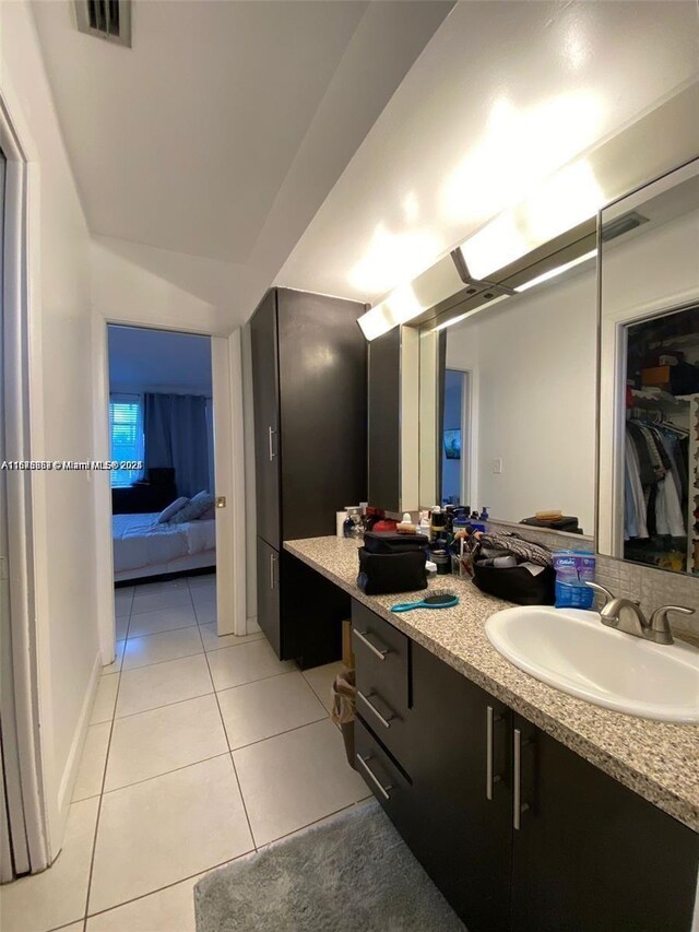 bathroom with tile walls, tile patterned floors, toilet, and shower / tub combo with curtain