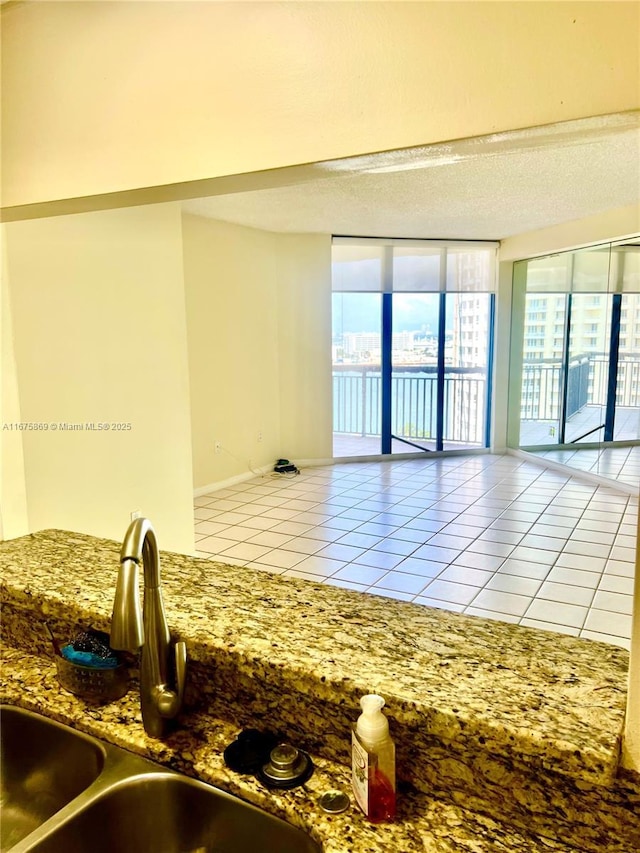 empty room featuring sink and light tile patterned floors