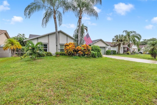 view of front of house with a front yard and a garage